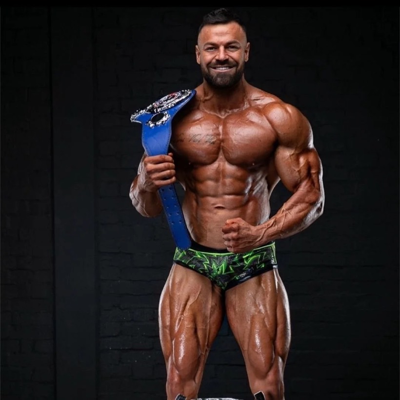 Team CJM Bodybuilding competitor on stage