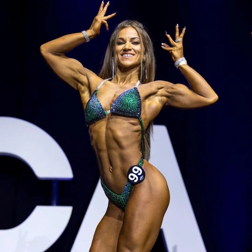 Team CJM Figure competitor on stage